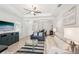 Bright living room with tile flooring, a tray ceiling, and comfortable seating at 12676 Sagewood Dr, Venice, FL 34293