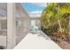 Cozy patio area surrounded by tropical landscaping, offering a private outdoor retreat at 12676 Sagewood Dr, Venice, FL 34293