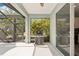 Outdoor patio featuring a grill, screened windows, and lush tropical view at 12676 Sagewood Dr, Venice, FL 34293