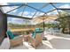 Inviting screened patio area with picturesque lake views for relaxing outdoor enjoyment at 12676 Sagewood Dr, Venice, FL 34293