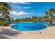 A beautiful swimming pool is surrounded by many palm trees, bright sunshine, and clear water at 12676 Sagewood Dr, Venice, FL 34293