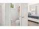 Neat toilet room and comfortable bedroom with a queen-sized bed with stylish patterned bedding at 12676 Sagewood Dr, Venice, FL 34293