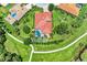 Single-Gathering home with inground pool surrounded by lush greenery, a paver patio, and sidewalks at 12838 Daisy Pl, Bradenton, FL 34212