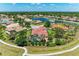 Aerial view of home and its surroundings, showcasing landscaping, tile roof, and convenient community access at 12838 Daisy Pl, Bradenton, FL 34212