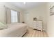 Serene bedroom featuring hardwood floors, a cozy bed, and natural light at 12838 Daisy Pl, Bradenton, FL 34212