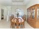Bright dining room with classic china cabinet and an elegant wooden table perfect for Gathering gatherings at 12838 Daisy Pl, Bradenton, FL 34212