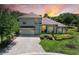 Charming two-story home with lush landscaping, a paver driveway, and a tile roof at 12838 Daisy Pl, Bradenton, FL 34212