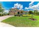 Lovely home featuring a well-maintained lawn, arched entryway, and a two-car garage for a polished curb appeal at 12838 Daisy Pl, Bradenton, FL 34212