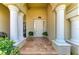 Inviting front porch with white columns and tiled flooring, creating a grand entrance to the home at 12838 Daisy Pl, Bradenton, FL 34212