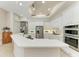 Open concept kitchen features stainless steel appliances, white cabinetry, and ample counter space at 12838 Daisy Pl, Bradenton, FL 34212