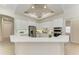 Contemporary kitchen with white cabinets, stainless steel appliances, and a functional island at 12838 Daisy Pl, Bradenton, FL 34212