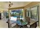 Inviting covered lanai with a dining table perfect for enjoying outdoor meals and a relaxing view of the pool area at 12838 Daisy Pl, Bradenton, FL 34212