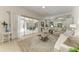 Open floor plan living room with access to the lanai and kitchen, featuring tile floors at 12838 Daisy Pl, Bradenton, FL 34212