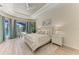 Tranquil main bedroom with tray ceiling, pool view, and comfortable decor at 12838 Daisy Pl, Bradenton, FL 34212