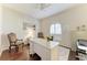 Home office featuring hardwood floors, a ceiling fan, and a bright window at 12838 Daisy Pl, Bradenton, FL 34212