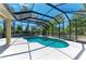 Inviting pool with screened enclosure, seamlessly blending indoor and outdoor living in a private, tropical setting at 12838 Daisy Pl, Bradenton, FL 34212