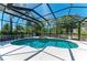 Enclosed screened pool with blue tile and attached hot tub area at 12838 Daisy Pl, Bradenton, FL 34212