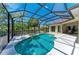 A screened pool with spa and outdoor patio creates a relaxing backyard oasis at 12838 Daisy Pl, Bradenton, FL 34212