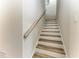 Bright staircase features light wood treads with white risers and a continuous handrail at 12838 Daisy Pl, Bradenton, FL 34212