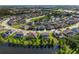 Aerial view showcasing a home with a pond view in a residential neighborhood with mature trees at 13116 Bliss Loop, Bradenton, FL 34211
