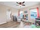 Bedroom with hardwood floors, ceiling fan, and a crib and glider with natural light at 13116 Bliss Loop, Bradenton, FL 34211