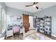 Bedroom with light blue walls, barn door access to the bathroom, and built in shelves at 13116 Bliss Loop, Bradenton, FL 34211