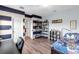 A spacious bedroom with hardwood floors and decorative shelving displays various collectibles at 13116 Bliss Loop, Bradenton, FL 34211