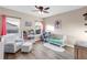 Bedroom with hardwood floors, ceiling fan, and a crib and glider with lots of light at 13116 Bliss Loop, Bradenton, FL 34211