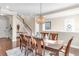 Dining room with hardwood floors, an elegant chandelier, and staircase to the second level at 13116 Bliss Loop, Bradenton, FL 34211
