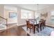 This dining room features dark hardwood floors, a stylish chandelier, and lots of light at 13116 Bliss Loop, Bradenton, FL 34211