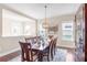 This dining room features dark hardwood floors, a stylish chandelier, and lots of light at 13116 Bliss Loop, Bradenton, FL 34211