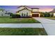 Charming two-story home featuring a well-manicured lawn and two car garage and beautiful landscaping at 13116 Bliss Loop, Bradenton, FL 34211