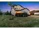 Beautiful two-story home with lush landscaping, palm trees, and a well-manicured lawn at 13116 Bliss Loop, Bradenton, FL 34211