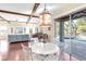 Open-concept living area with wood beam ceilings, hardwood floors, and access to the pool at 13116 Bliss Loop, Bradenton, FL 34211