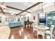 Inviting living area with view to outdoor pool featuring dark hardwood floors, piano, and comfortable seating at 13116 Bliss Loop, Bradenton, FL 34211