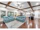 Open-concept living area with wood beam ceilings, hardwood floors, and modern kitchen at 13116 Bliss Loop, Bradenton, FL 34211