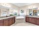 Bathroom with dual vanities, garden tub, and a large window for natural light and neighborhood views at 13116 Bliss Loop, Bradenton, FL 34211