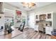 Office space with wood floors, ceiling fan, and built-in desk with hutch and lots of natural light at 13116 Bliss Loop, Bradenton, FL 34211