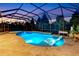 Beautiful screened-in pool with a lounge chair, lush landscaping, and ample space for relaxation at 13116 Bliss Loop, Bradenton, FL 34211