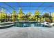 Stunning screened-in pool with waterfall features and lounge chairs surrounded by a lush landscape at 13116 Bliss Loop, Bradenton, FL 34211