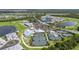 An aerial view shows a community with tennis courts, a pool, clubhouse, and a golf course at 14184 Heritage Landing Blvd # 513, Punta Gorda, FL 33955