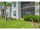 Exterior view of backyard featuring a well-maintained lawn and screened in lanais at 14184 Heritage Landing Blvd # 513, Punta Gorda, FL 33955