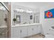 Bright bathroom with double sink vanity, large mirror, and walk-in shower that provides ample space at 14184 Heritage Landing Blvd # 513, Punta Gorda, FL 33955