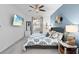 Comfortable bedroom featuring a ceiling fan, wall decor, and a window with natural light at 14184 Heritage Landing Blvd # 513, Punta Gorda, FL 33955