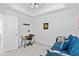 Small bedroom with desk, blue sofa, and door at 14184 Heritage Landing Blvd # 513, Punta Gorda, FL 33955