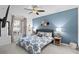 Cozy bedroom with blue accent wall, patterned bedding, and natural light from the window at 14184 Heritage Landing Blvd # 513, Punta Gorda, FL 33955