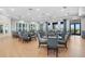 Bright, open dining room featuring light wood flooring, gray dining furniture, and several doors for easy access at 14184 Heritage Landing Blvd # 513, Punta Gorda, FL 33955