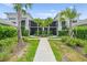 Inviting exterior view of condo with landscaped walkway, palm trees and screened lanais at 14184 Heritage Landing Blvd # 513, Punta Gorda, FL 33955
