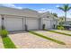 Exterior view of multiple garages featuring brick driveways and well-kept lawns at 14184 Heritage Landing Blvd # 513, Punta Gorda, FL 33955
