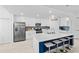 Modern white kitchen with stainless steel appliances, a center island, and barstool seating at 14184 Heritage Landing Blvd # 513, Punta Gorda, FL 33955
